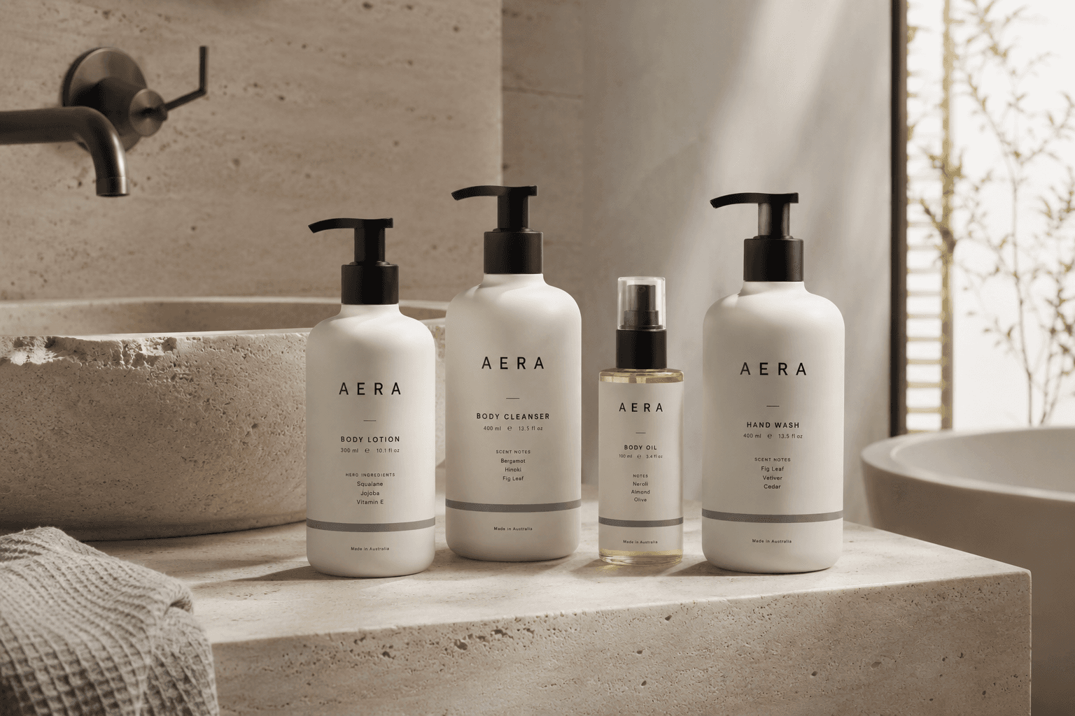 AERA bodycare collection with considered packaging beside a stone basin